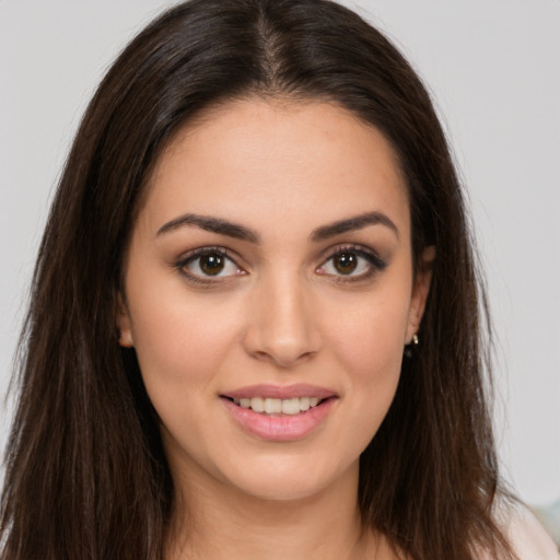 Joyful white young-adult female with long  brown hair and brown eyes