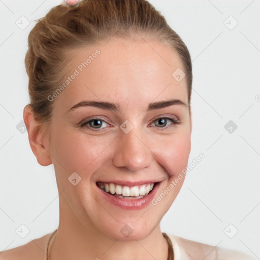 Joyful white young-adult female with short  brown hair and blue eyes