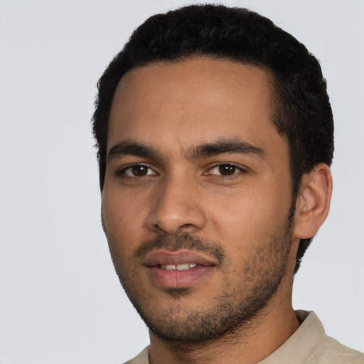 Joyful latino young-adult male with short  black hair and brown eyes