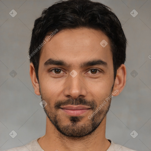 Joyful latino young-adult male with short  black hair and brown eyes