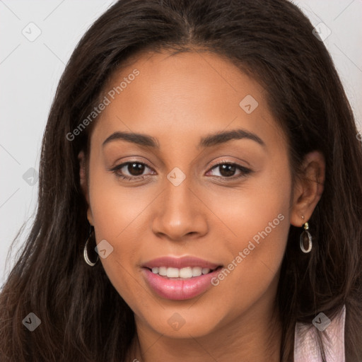 Joyful latino young-adult female with long  brown hair and brown eyes