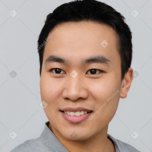 Joyful asian young-adult male with short  black hair and brown eyes