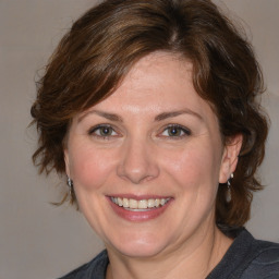 Joyful white adult female with medium  brown hair and brown eyes