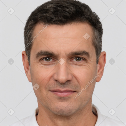 Joyful white adult male with short  brown hair and brown eyes