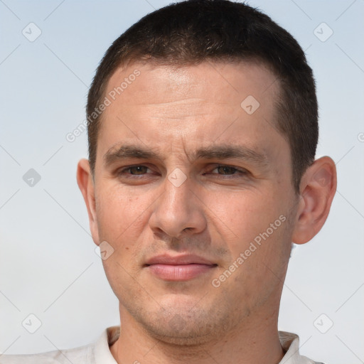 Joyful white young-adult male with short  brown hair and brown eyes