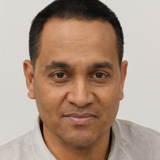 Joyful black adult male with short  brown hair and brown eyes