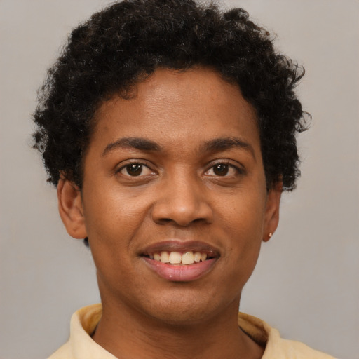Joyful black young-adult female with short  brown hair and brown eyes
