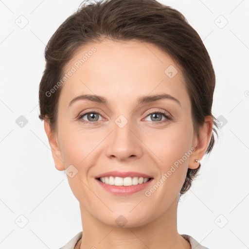 Joyful white young-adult female with short  brown hair and grey eyes