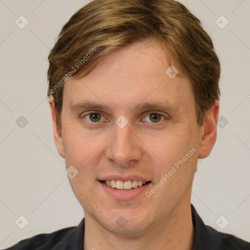 Joyful white young-adult male with short  brown hair and grey eyes