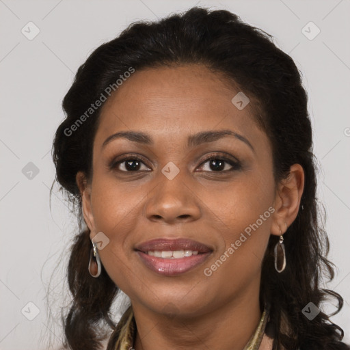 Joyful black young-adult female with long  brown hair and brown eyes