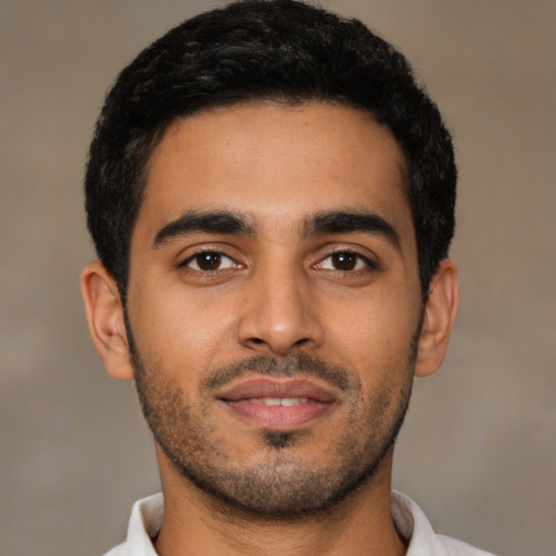 Joyful latino young-adult male with short  black hair and brown eyes