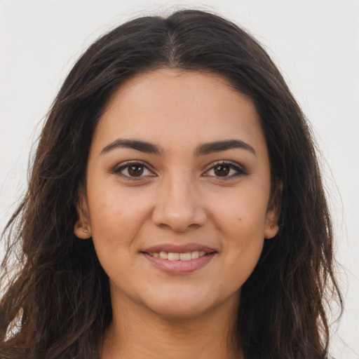 Joyful latino young-adult female with long  brown hair and brown eyes