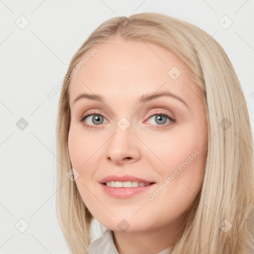 Joyful white young-adult female with long  brown hair and blue eyes