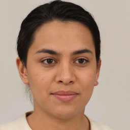 Joyful latino young-adult female with short  brown hair and brown eyes