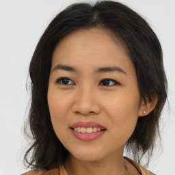 Joyful asian young-adult female with long  brown hair and brown eyes