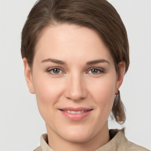 Joyful white young-adult female with short  brown hair and grey eyes