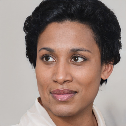 Joyful latino adult female with short  black hair and brown eyes