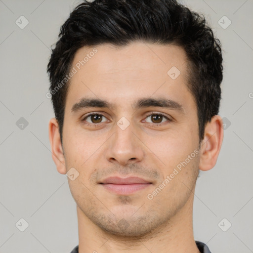 Joyful white young-adult male with short  black hair and brown eyes