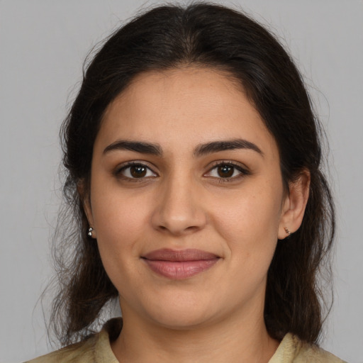 Joyful latino young-adult female with medium  brown hair and brown eyes