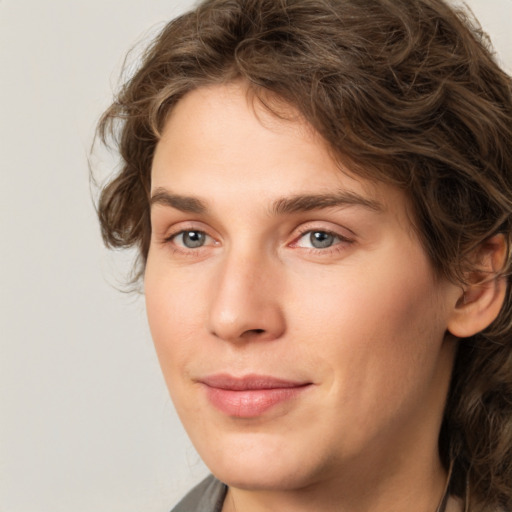 Joyful white young-adult female with medium  brown hair and green eyes