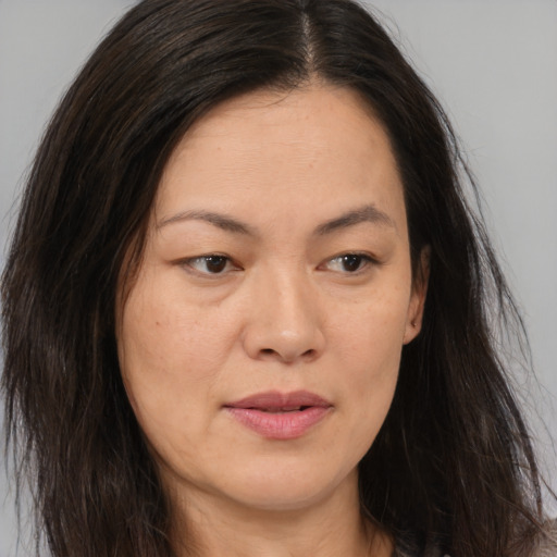 Joyful asian young-adult female with long  brown hair and brown eyes
