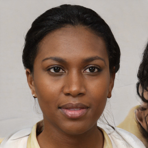 Joyful black young-adult female with medium  black hair and brown eyes