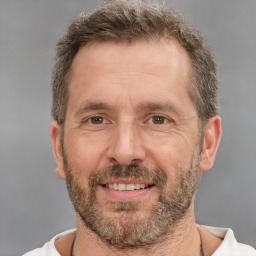 Joyful white adult male with short  brown hair and brown eyes