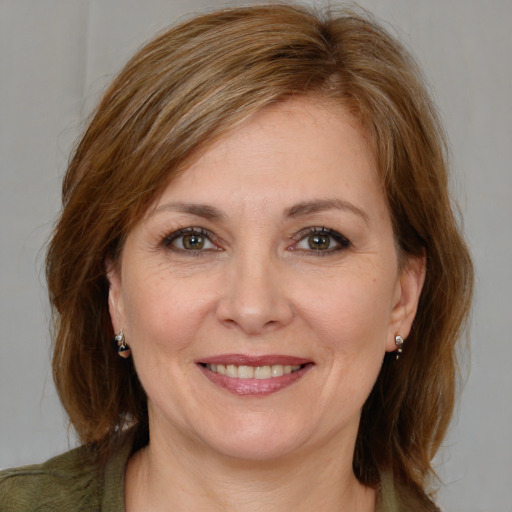 Joyful white young-adult female with medium  brown hair and grey eyes