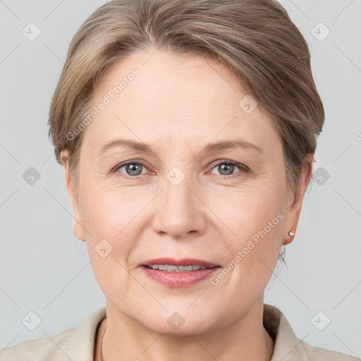 Joyful white adult female with short  brown hair and grey eyes