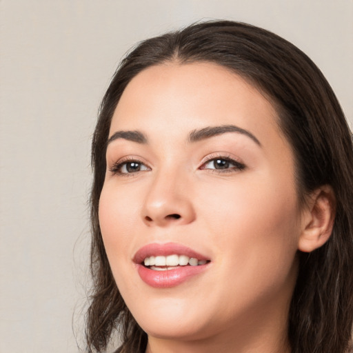 Joyful white young-adult female with long  black hair and brown eyes