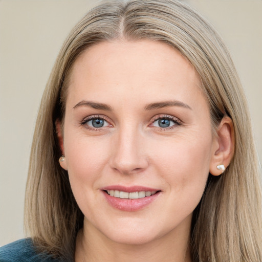 Joyful white young-adult female with long  brown hair and blue eyes