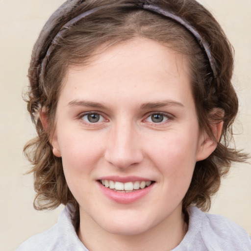 Joyful white young-adult female with medium  brown hair and blue eyes