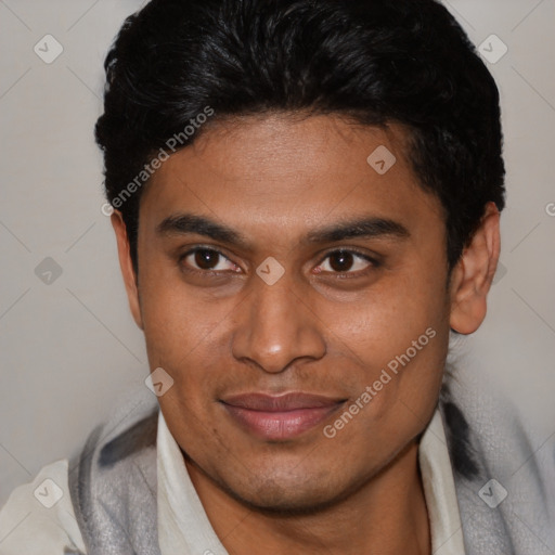 Joyful latino young-adult male with short  brown hair and brown eyes