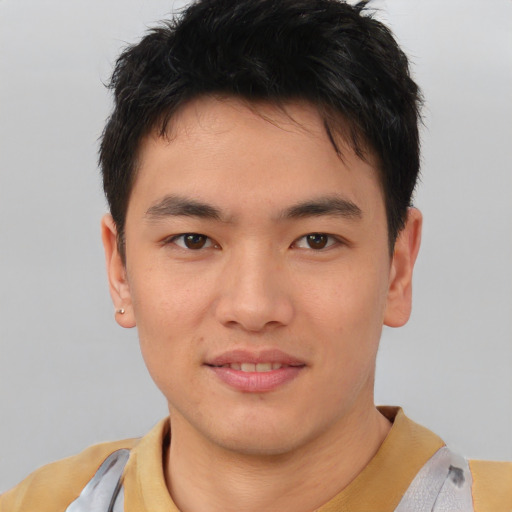 Joyful asian young-adult male with short  brown hair and brown eyes