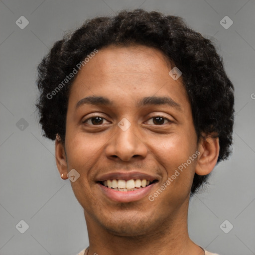 Joyful latino young-adult male with short  brown hair and brown eyes