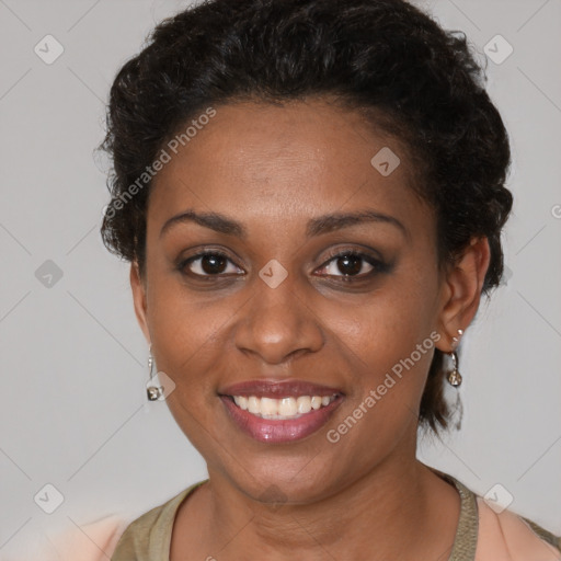 Joyful black young-adult female with short  brown hair and brown eyes