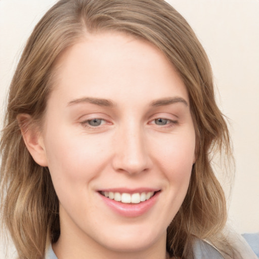 Joyful white young-adult female with medium  brown hair and blue eyes