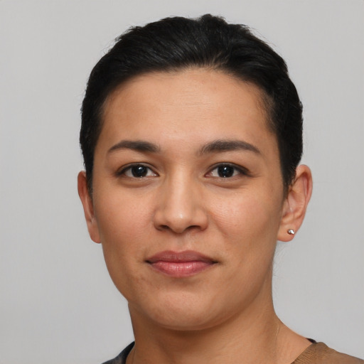 Joyful latino young-adult female with short  black hair and brown eyes