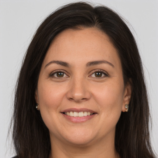 Joyful white adult female with long  brown hair and brown eyes