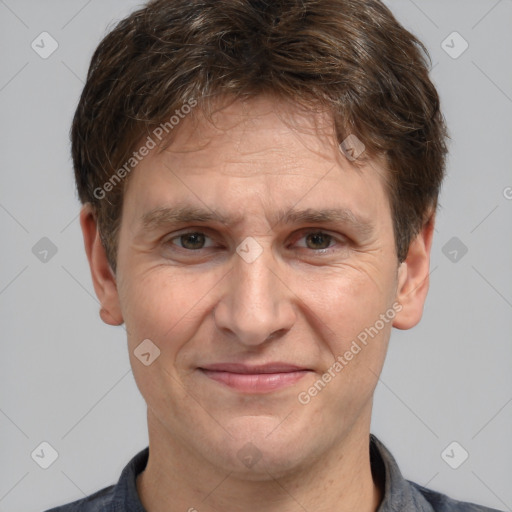 Joyful white adult male with short  brown hair and grey eyes