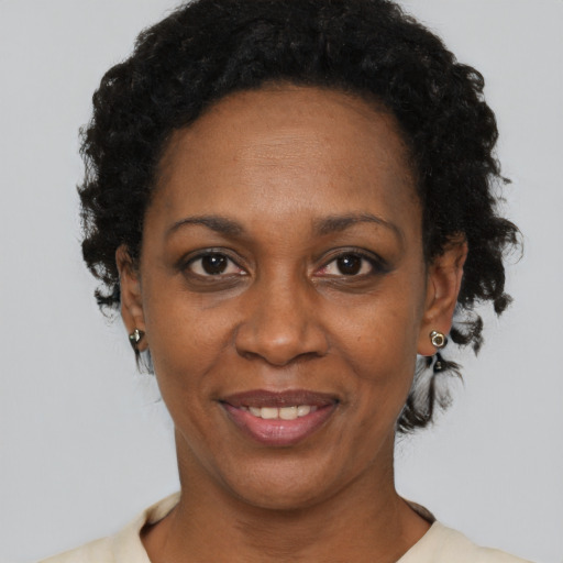 Joyful black adult female with short  black hair and brown eyes