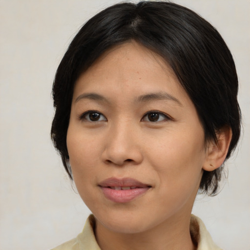 Joyful asian young-adult female with medium  brown hair and brown eyes