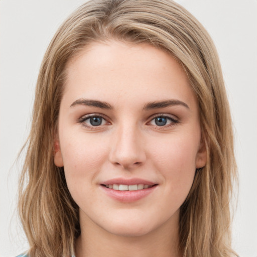 Joyful white young-adult female with long  brown hair and green eyes