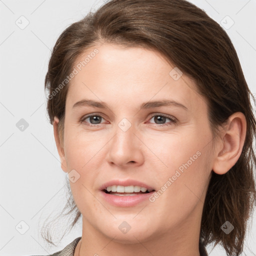 Joyful white young-adult female with medium  brown hair and grey eyes