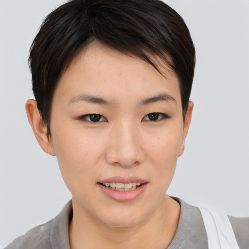 Joyful asian young-adult female with short  brown hair and brown eyes