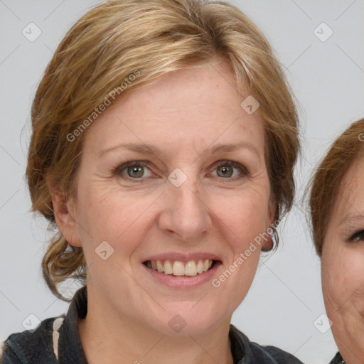 Joyful white adult female with medium  brown hair and grey eyes