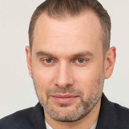 Joyful white adult male with short  brown hair and brown eyes