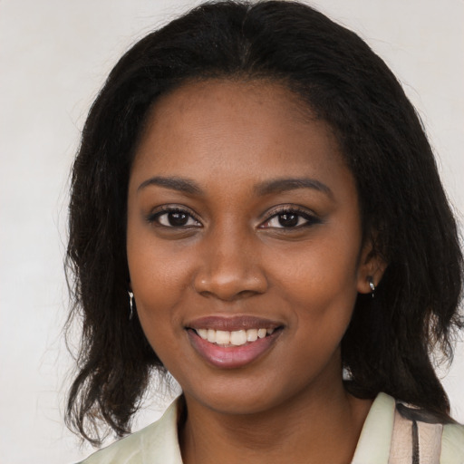 Joyful black young-adult female with medium  brown hair and brown eyes