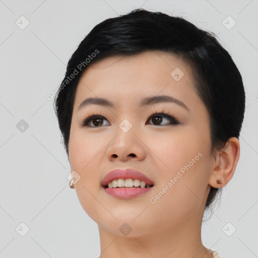 Joyful asian young-adult female with medium  black hair and brown eyes