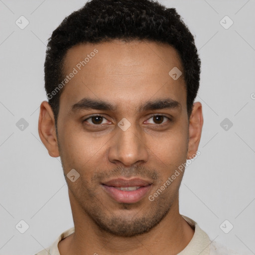 Joyful black young-adult male with short  brown hair and brown eyes